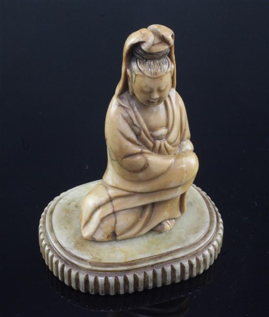 A Chinese soapstone seated figure of Guanyin, 17th / 18th century, 10cm, label for R & V Tregaskis